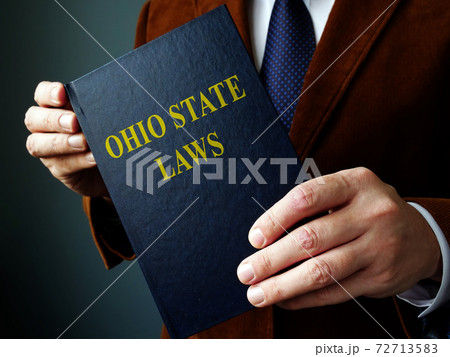 Ohio state law concept. The man is holding a book. Ohio state law concept. The man is holding a book. 72713583
