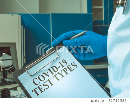 The doctor keeps the covid 19 test types list. 72713585