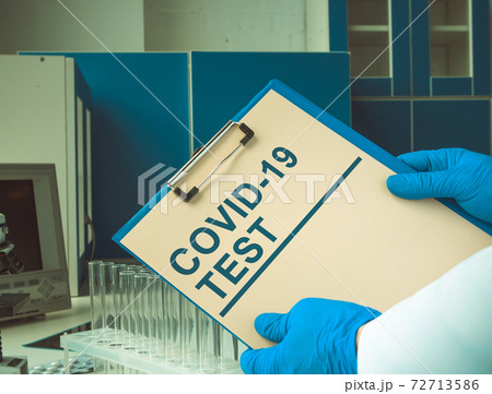 Doctor holds the results of a covid 19 test in the laboratory. 72713586