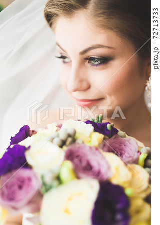 Beautiful bride wearing fashion wedding dress with feathers with luxury delight make-up and hairstyle, studio indoor photo shoot 72713733