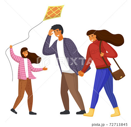 Happy family parents and daughter with kite walking in the city park together in windy weather 72713845