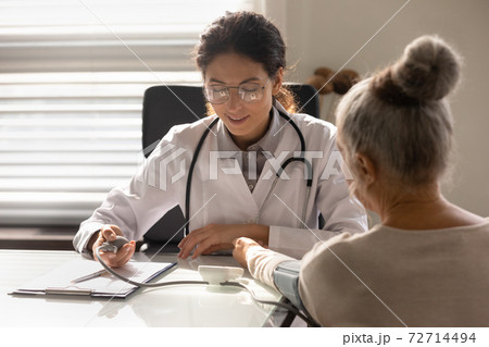 Female nurse examine mature patient at consultation 72714494