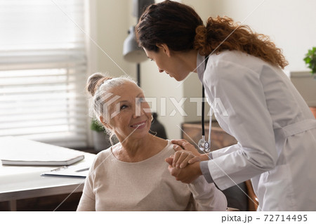 Caring female doctor comfort senior patient in hospital Caring female doctor comfort senior patient in hospital 72714495