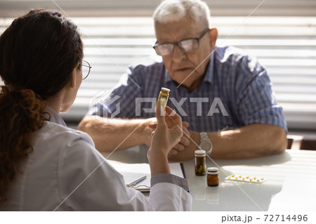 Female doctor recommend medicines to sick mature patient Female doctor recommend medicines to sick mature patient 72714496