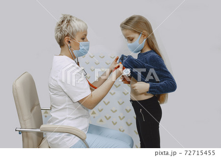 Happy little girl at the doctor for a checkup Happy little girl at the doctor for a checkup 72715455