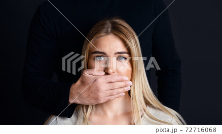 Shut up and listen. Male hand closes woman mouth and prevents her from talking about feelings 72716068