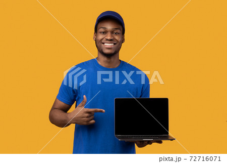 Black delivery man holding laptop with blank screen for mockup Black delivery man holding laptop with blank screen for mockup 72716071