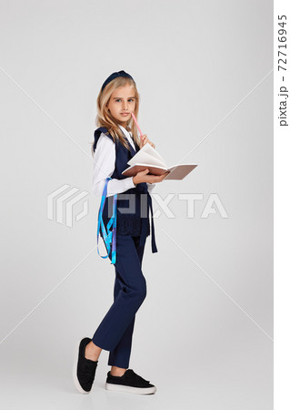 happy little girl holding tape measure 72716945