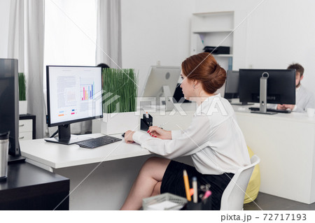 An employee of the LLC works with investment documents on the computer. Closing and opening trades on the basis of the graphs of sales. An employee of the LLC works with investment documents on the computer. Closing and opening trades on the basis of the graphs of sales. 72717193