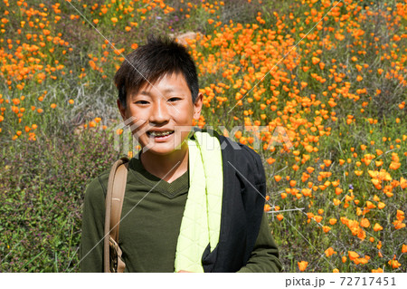 Young sporty Asian boy enjoying and hiking the mountain during the California Golden Poppy Young sporty Asian boy enjoying and hiking the mountain during the California Golden Poppy 72717451