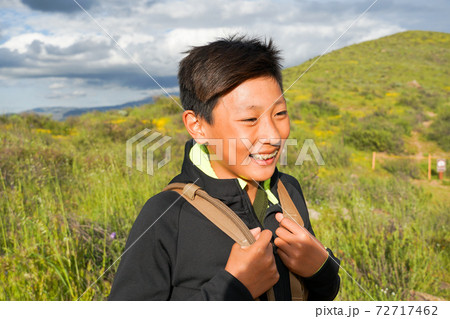 Young sporty Asian boy enjoying and hiking the mountain during the California Golden Poppy  72717462