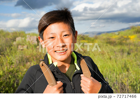 Young sporty Asian boy enjoying and hiking the mountain during the California Golden Poppy  72717466