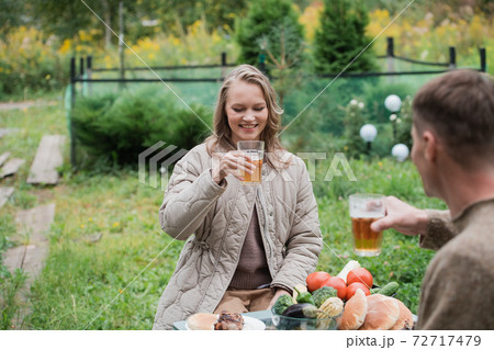 Buying a new home by a young family. A husband and wife on their own land plot had a picnic with beer and barbecue meat. 72717479