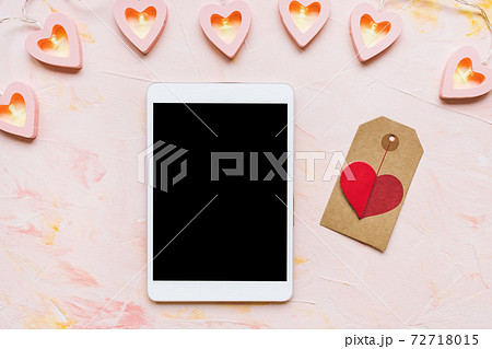 Digital tablet on Valentines Day pink background 72718015