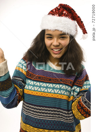 cute young real african hipster girl in santas red hat isolated on white background waiting for winter Christmass 72719000