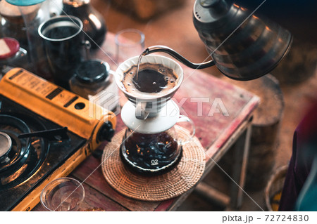 Drip coffee, barista pouring water on coffee ground with filter 72724830