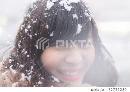 雪の降る京都 髪に積もる雪と笑う女性の顔のアップ 雪の降る京都 髪に積もる雪と笑う女性の顔のアップ 72725282
