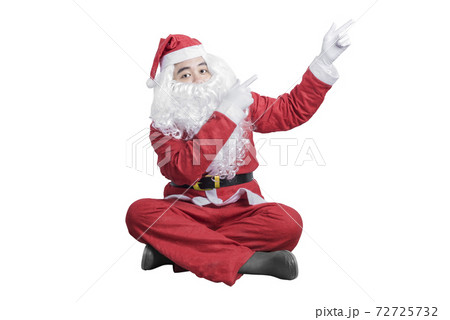 Asian man in Santa costume pointing something Asian man in Santa costume pointing something 72725732