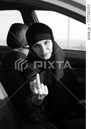The woman driver shows an indecent gesture. Raised middle finger 72738103