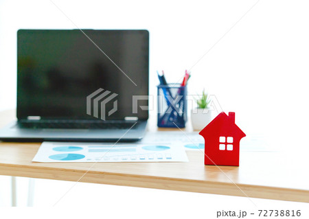 Concept of property investment, Laptop and papers on desk in front of window Concept of property investment, Laptop and papers on desk in front of window 72738816