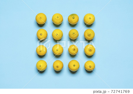 Lemons top view on blue background. Lemons aligned symmetrically Lemons top view on blue background. Lemons aligned symmetrically 72741769