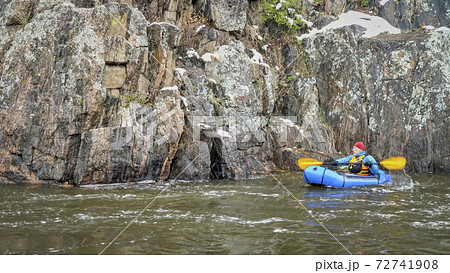 packraft  paddling in snowstorm 72741908