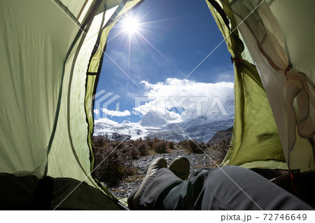 Hiker enjoy the beautiful landscape in tent Hiker enjoy the beautiful landscape in tent 72746649