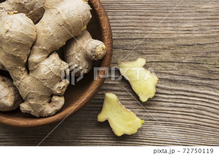 Bowl with fresh ginger on wooden table Bowl with fresh ginger on wooden table 72750119