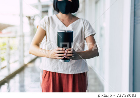 Asian woman using reusable drink bottle,Healthy green,Environmental friendly,Zero waste,Conscious lifestyle concept 72753083