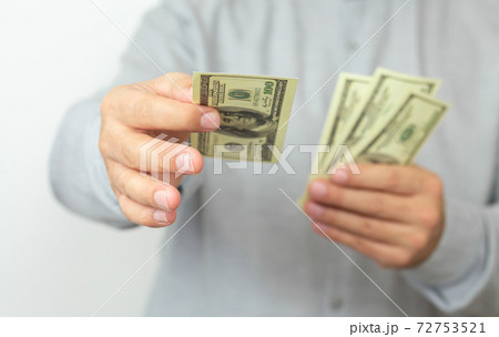 Hands of man proposing money us dollar bills to you 72753521