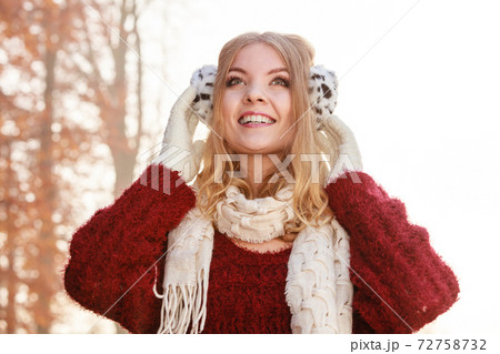 Portrait of pretty smiling woman in earmuffs. Portrait of pretty smiling woman in earmuffs. 72758732