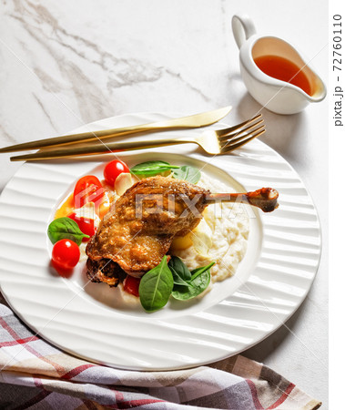 Roasted duck leg with puree and orange sauce 72760110