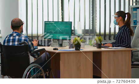 Lady with face mask bringing immobilized man at workplace Lady with face mask bringing immobilized man at workplace 72760430