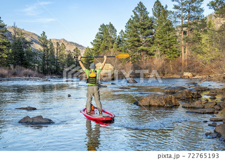 stand up paddling on mountain river stand up paddling on mountain river 72765193