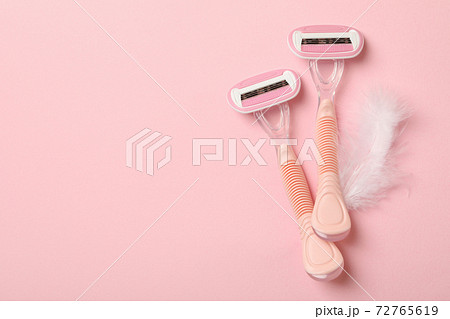 Razors on pink background, space for text 72765619
