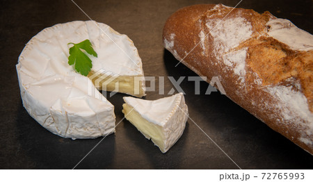 Camembert cheese on a wooden background 72765993