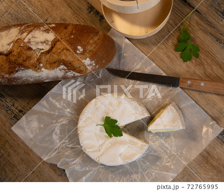 Camembert cheese on a wooden background 72765995