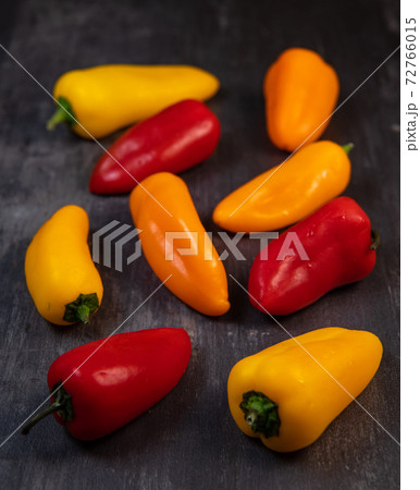 Assorted ripe multi-colored baby peppers, red, orange and yellow 72766015