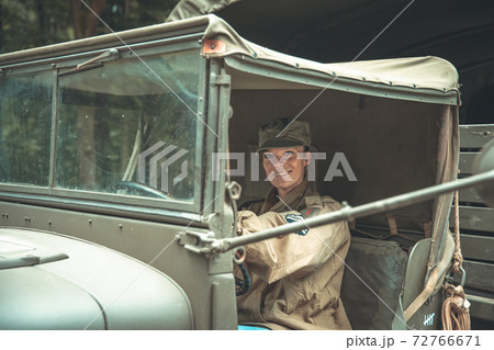 woman in a military uniform in an army car woman in a military uniform in an army car 72766671