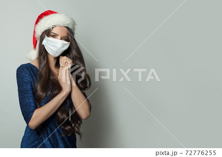 Attractive Christmas woman wearing protective medical mask Attractive Christmas woman wearing protective medical mask 72776255