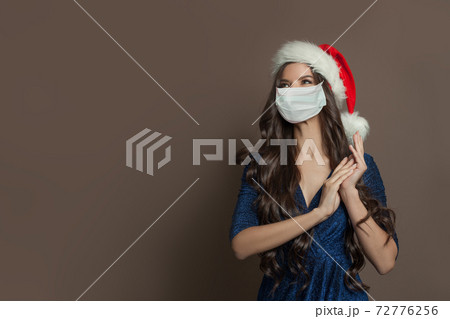 Happy Christmas woman in protective medical mask Happy Christmas woman in protective medical mask 72776256