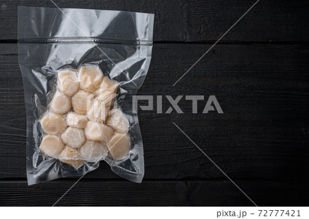 Frozen meat scallop in vacuum package, flat lay with space for text Frozen meat scallop in vacuum package, flat lay with space for text 72777421
