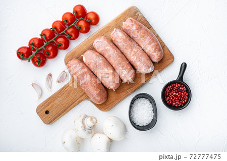 Raw pork sausages, top view, on white background Raw pork sausages, top view, on white background 72777475