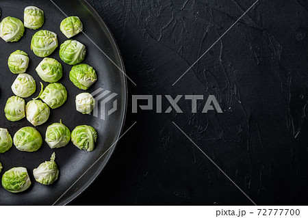 Brussels sprouts, on black textured background, top view with space for text 72777700