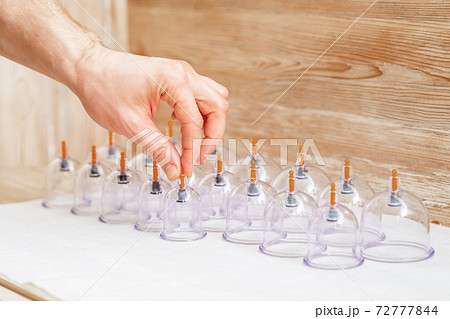 Hand takes vacuum glass jar. Hand takes vacuum glass jar. 72777844