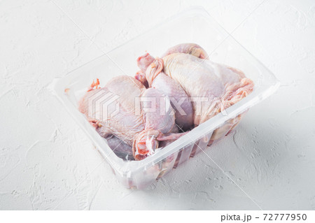 Raw chicken in plastic vacuum tray, on white background 72777950