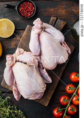 Whole raw free range chicken with ingredients, on old wooden table, top view 72778046
