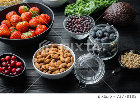 Superfoods dieting concept, on black wooden background Superfoods dieting concept, on black wooden background 72778185
