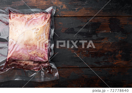 Marbled beef steak cut in vacuum pack, on dark wooden background, top view, with copy space for text Marbled beef steak cut in vacuum pack, on dark wooden background, top view, with copy space for text 72778640