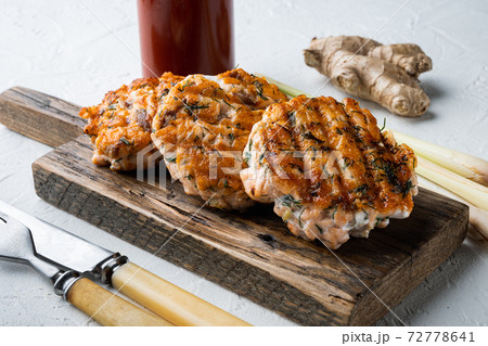 Grilled quick asian salmon cutlets, on white textured background Grilled quick asian salmon cutlets, on white textured background 72778641